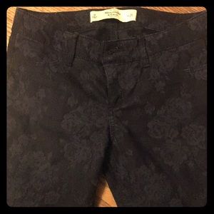 Dark blue skinny jeans with same color flowers